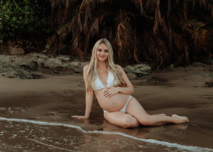 Maternity Photographer, Mother in bathing suit holding her belly